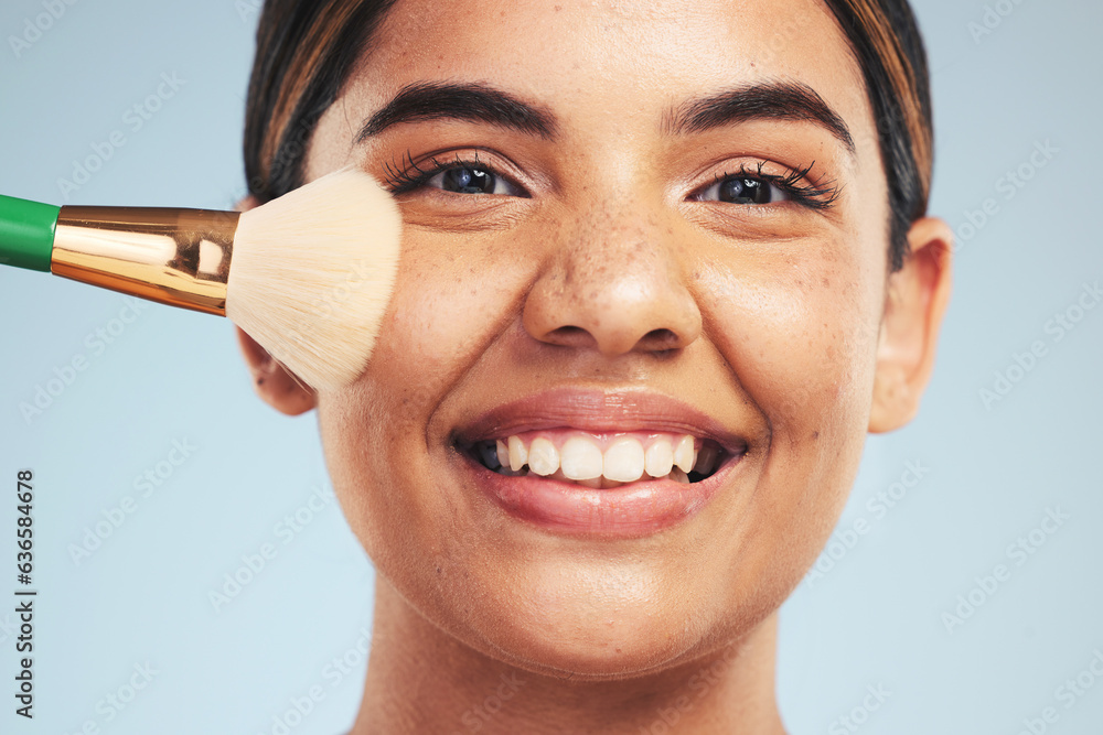 Portrait, woman and smile with makeup brush in studio, apply foundation and glow on blue background.