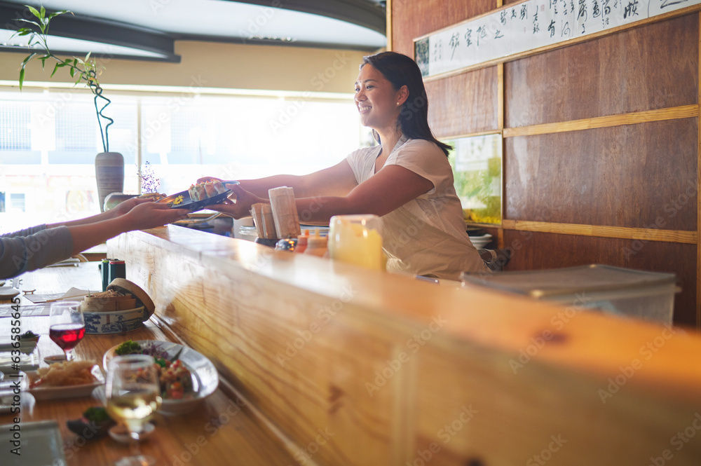 Sushi serving, restaurant chef and woman with smile from food and Asian meal in a kitchen. Happy, fe