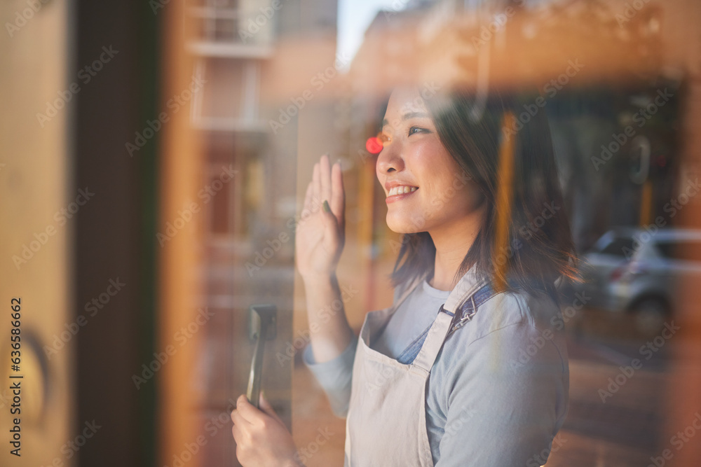 Asian woman, window and door of restaurant to welcome service, small business owner and wave with re