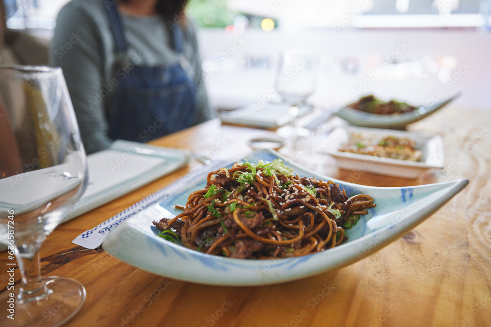 Plate, eating and noodles at a restaurant on a table for Chinese food at lunch. Closeup, health and 