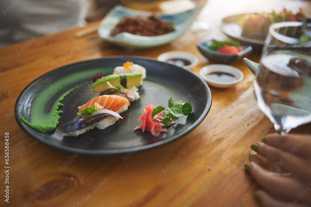 Plate, table and sushi with a person at a restaurant for fish, lunch or seafood dinner. Closeup, hun