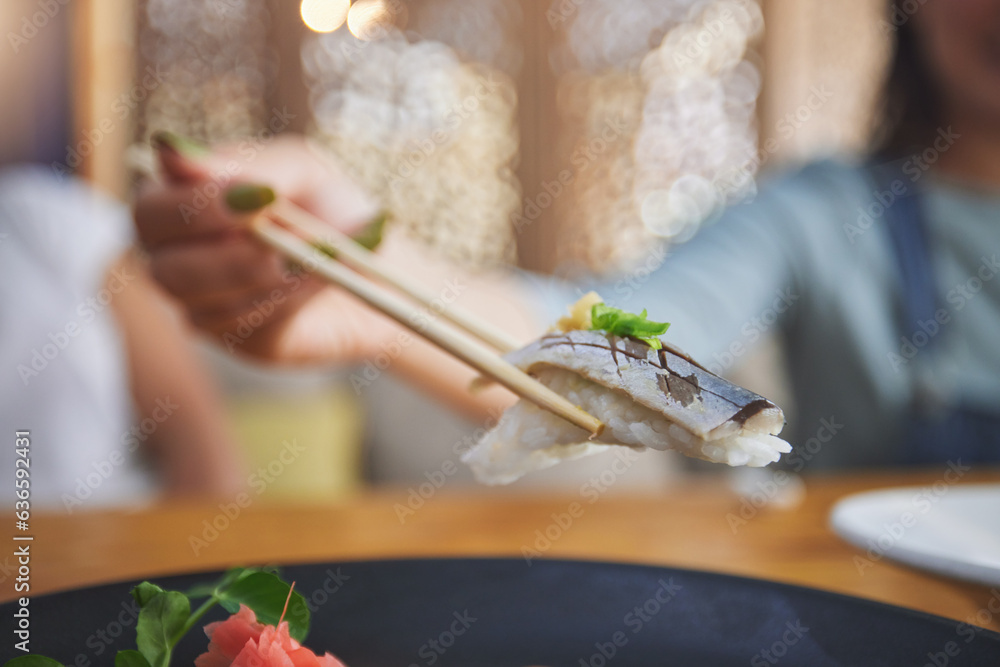 Food, hand and eating sushi with chopsticks at restaurant for nutrition and health. Closeup of a hun