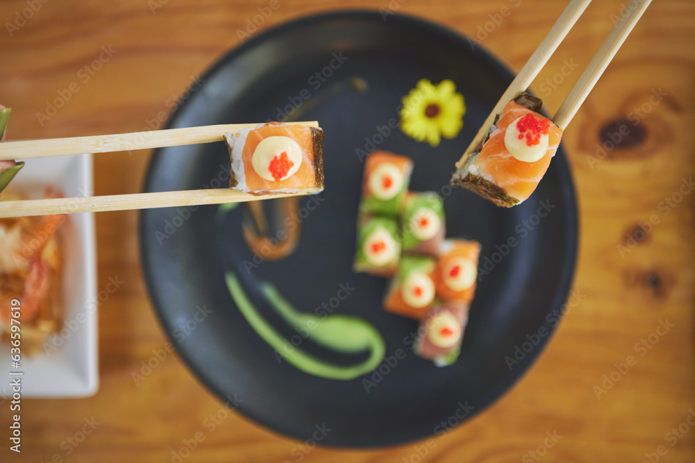 Sushi, seafood and chopsticks in a chinese restaurant from above for dining or traditional cuisine. 