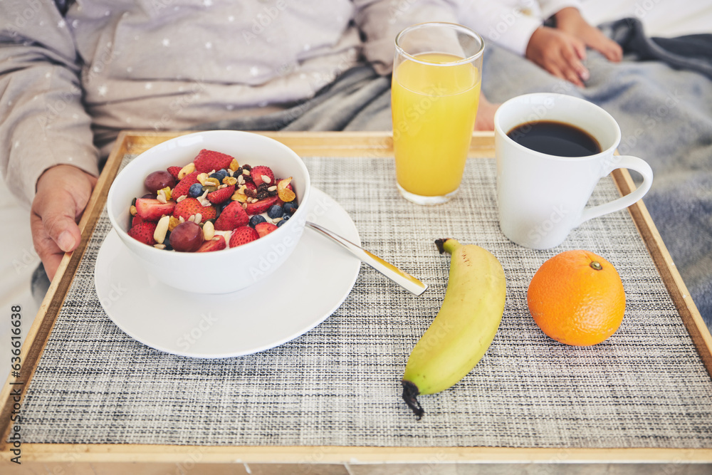 Tray, hands and closeup of healthy breakfast in bed in the room of modern house on a weekend. Mornin