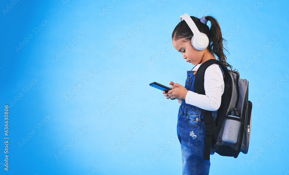 Music, backpack and child on blue background with phone ready for school, learning and education. Ki