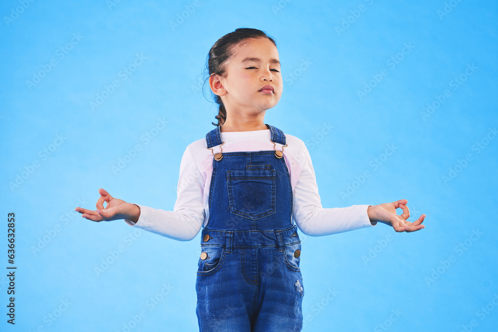 Girl child, zen and meditation in studio with eyes closed, peace and wellness by blue background. Fe