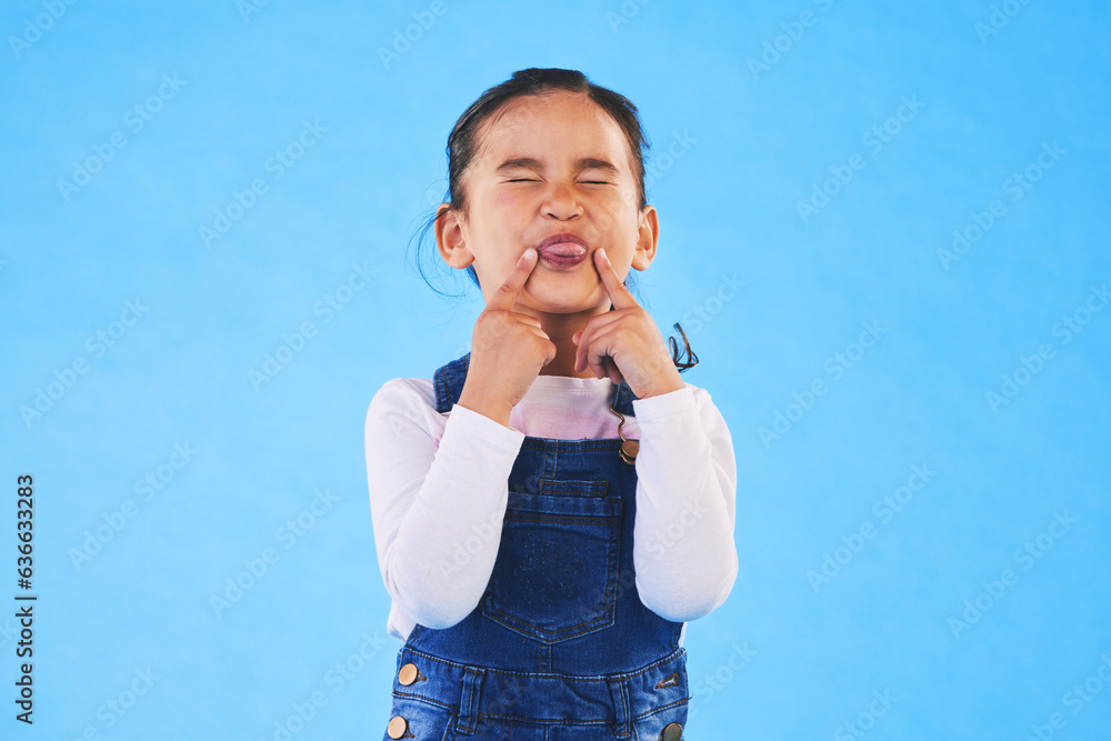 Child, funny, face and girl with silly, goofy or facial expression on blue background in studio with