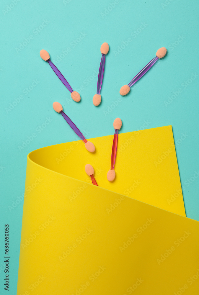 Set of applicators for makeup on a yellow blue background