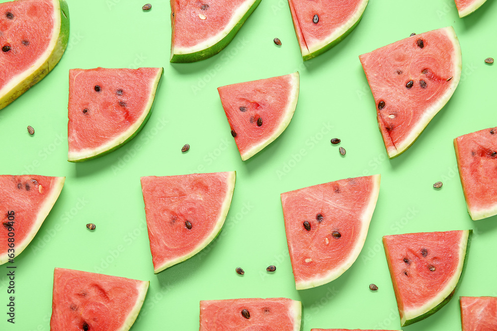 Composition with with pieces of ripe watermelon on green background