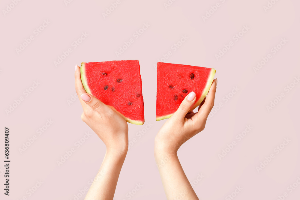 Female hands with pieces of ripe watermelon on beige background