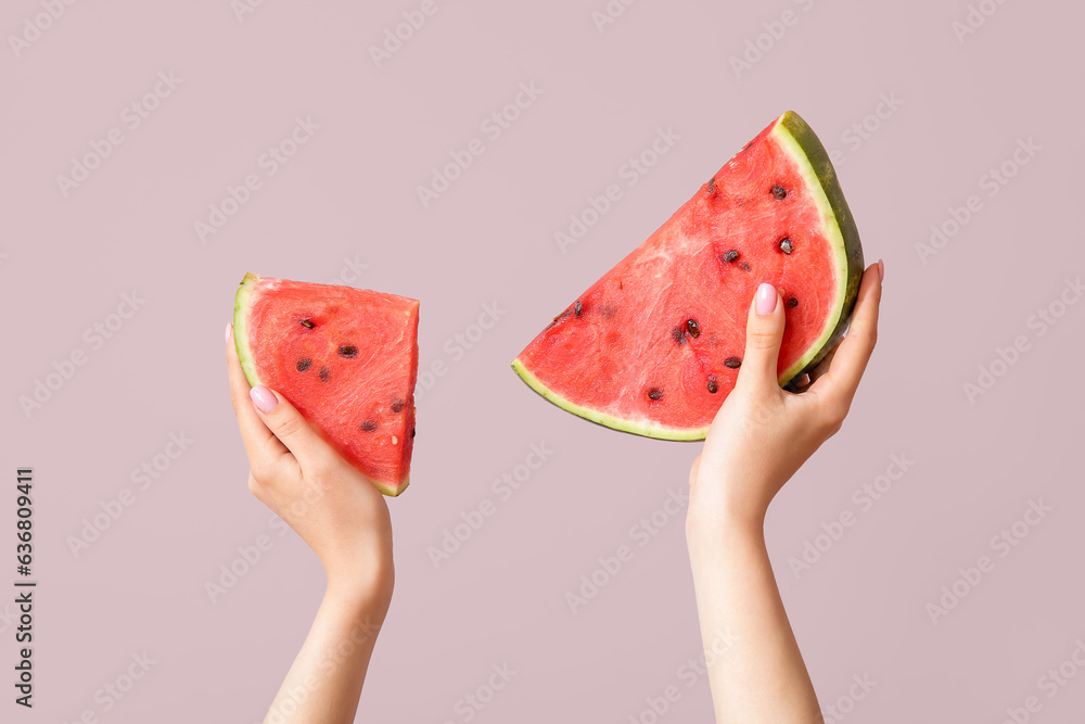 Female hands with pieces of ripe watermelon on beige background