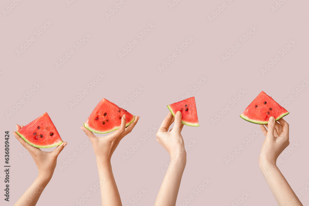 Female hands with pieces of ripe watermelon on beige background