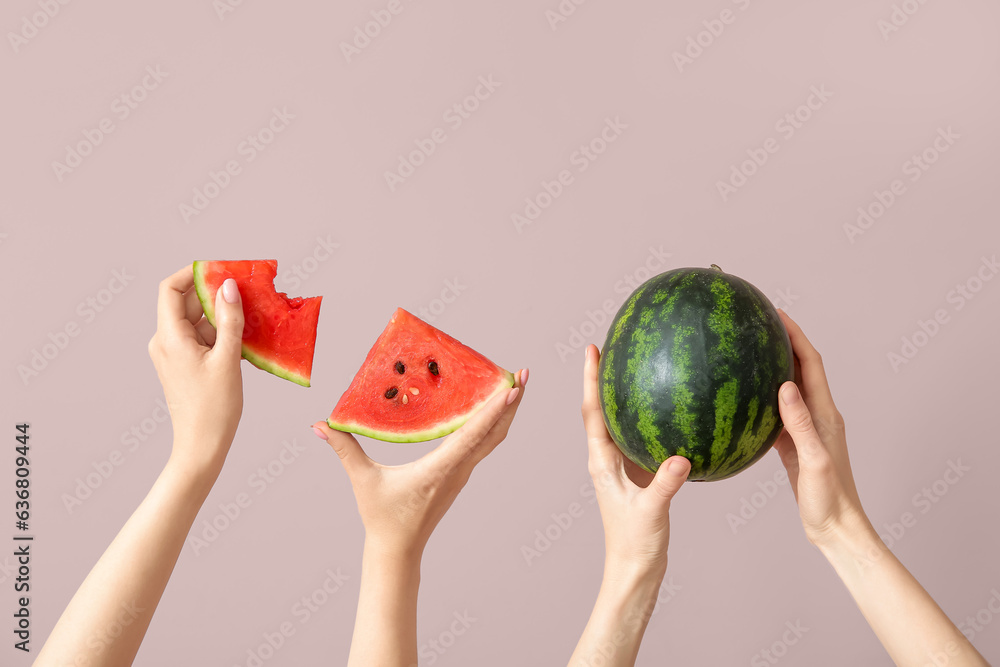 Female hands with whole ripe watermelon and pieces on beige background