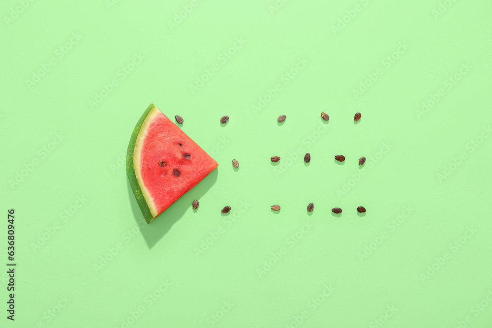 Composition with piece of ripe fresh watermelon and seeds on green background