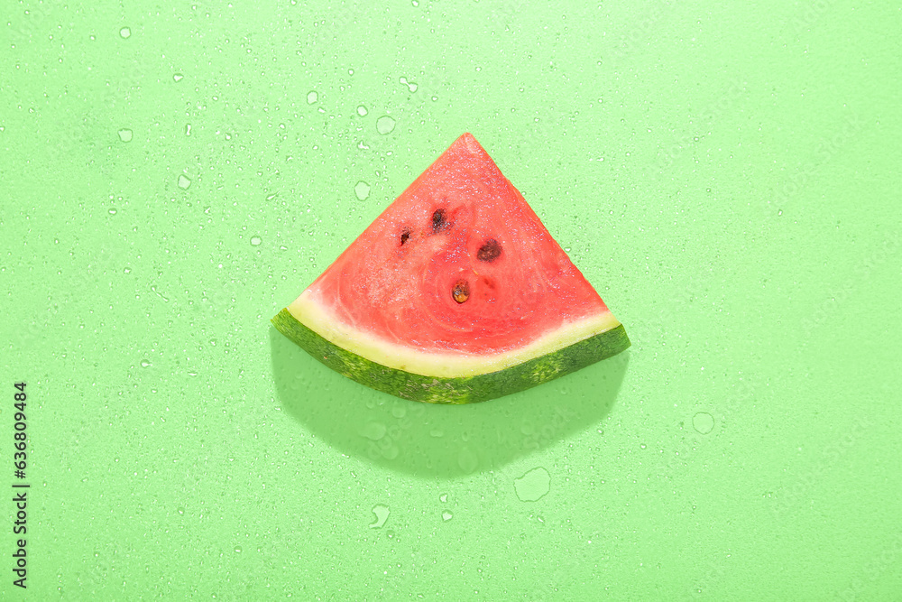 Piece of ripe watermelon on green background