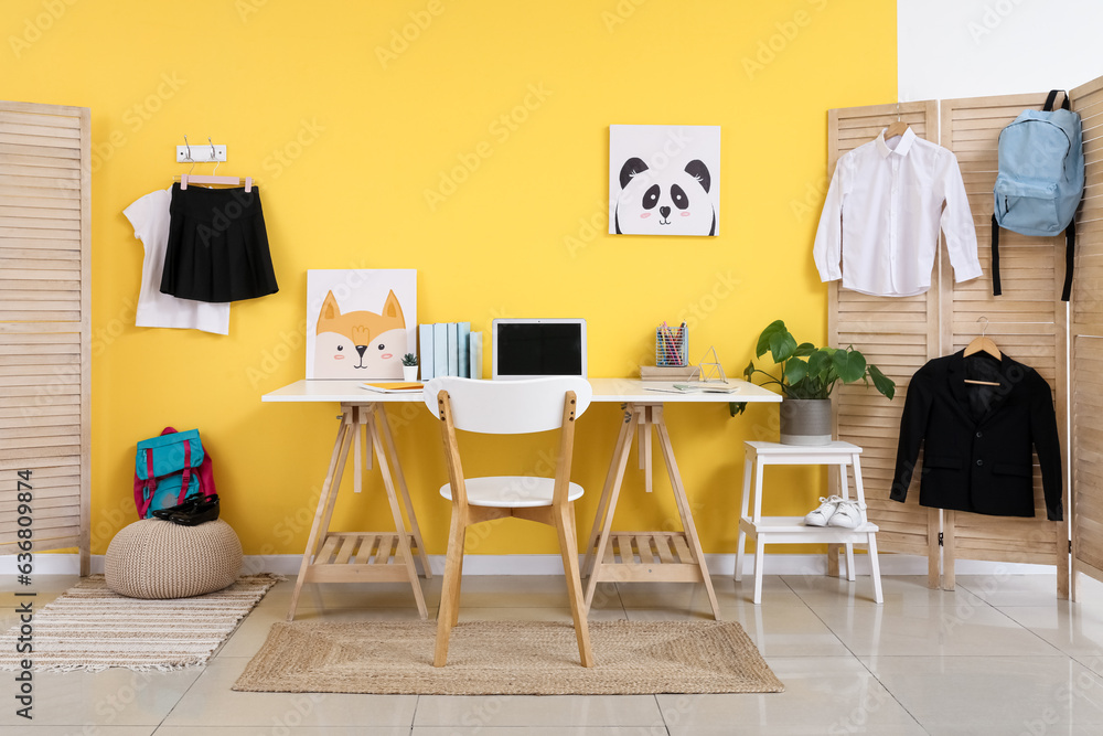 Interior of modern room with workplace and stylish school uniform