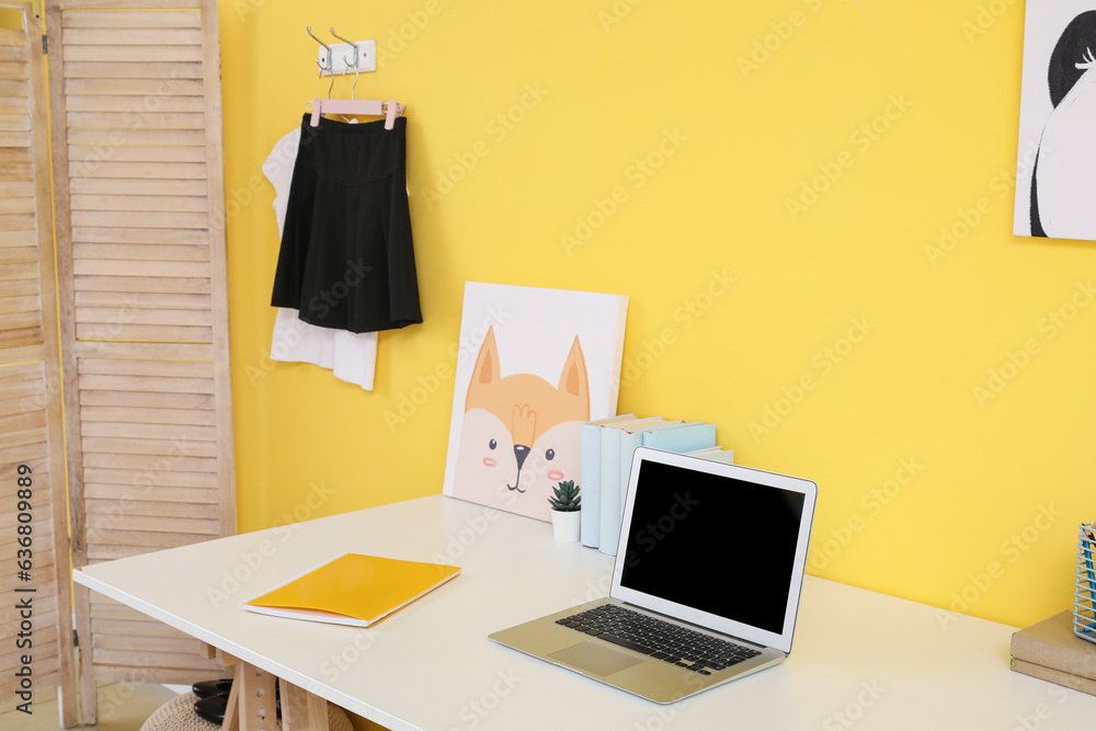 Interior of modern room with workplace and stylish school uniform