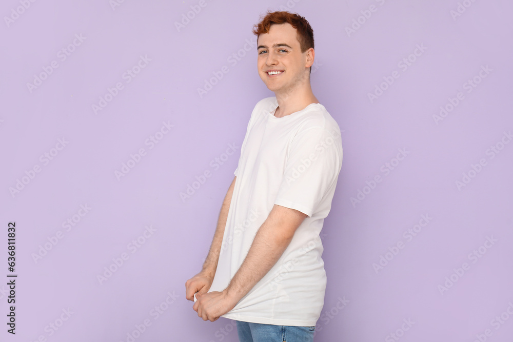 Young man in white t-shirt on lilac background