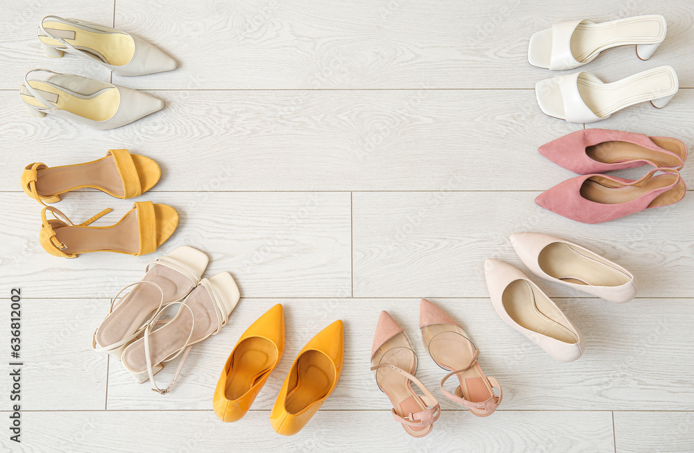 Composition with different female shoes on light floor