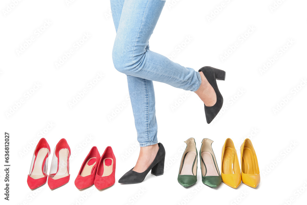 Woman with different shoes on white background