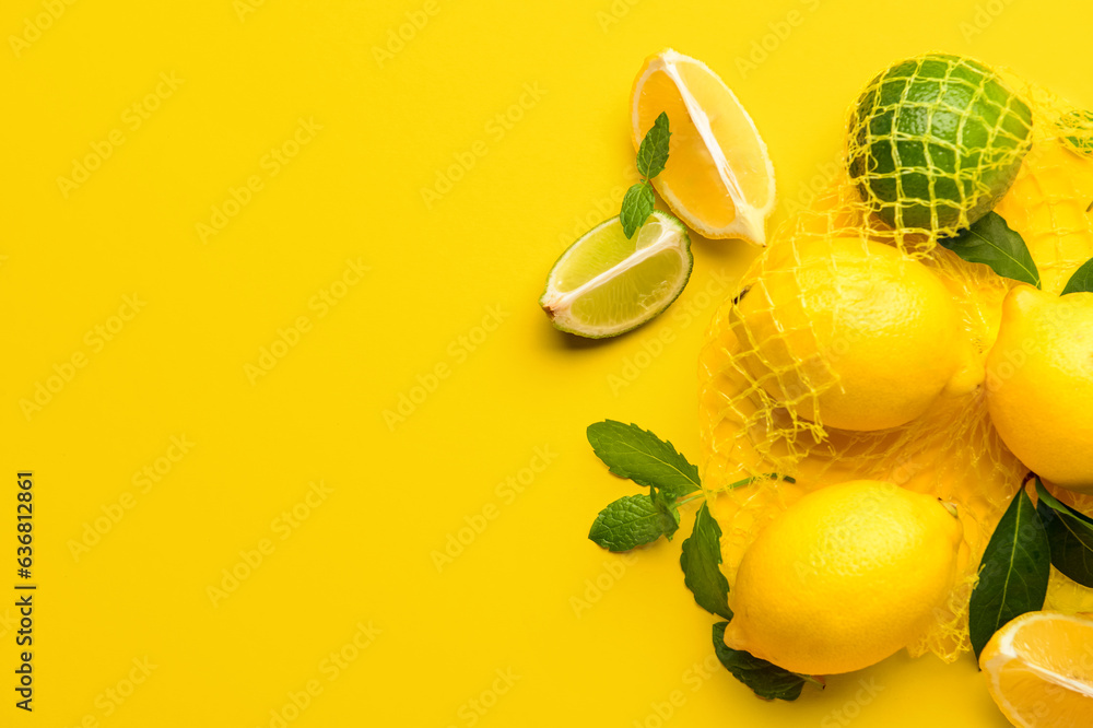 Mesh bag with fresh lemons and limes on yellow background