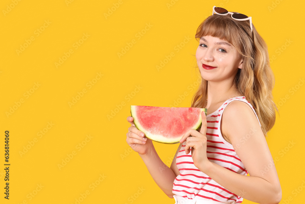 Young woman with fresh watermelon on orange background