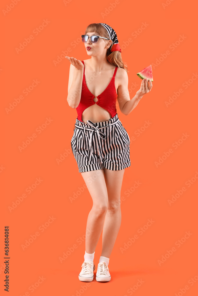 Young woman with fresh watermelon on red background