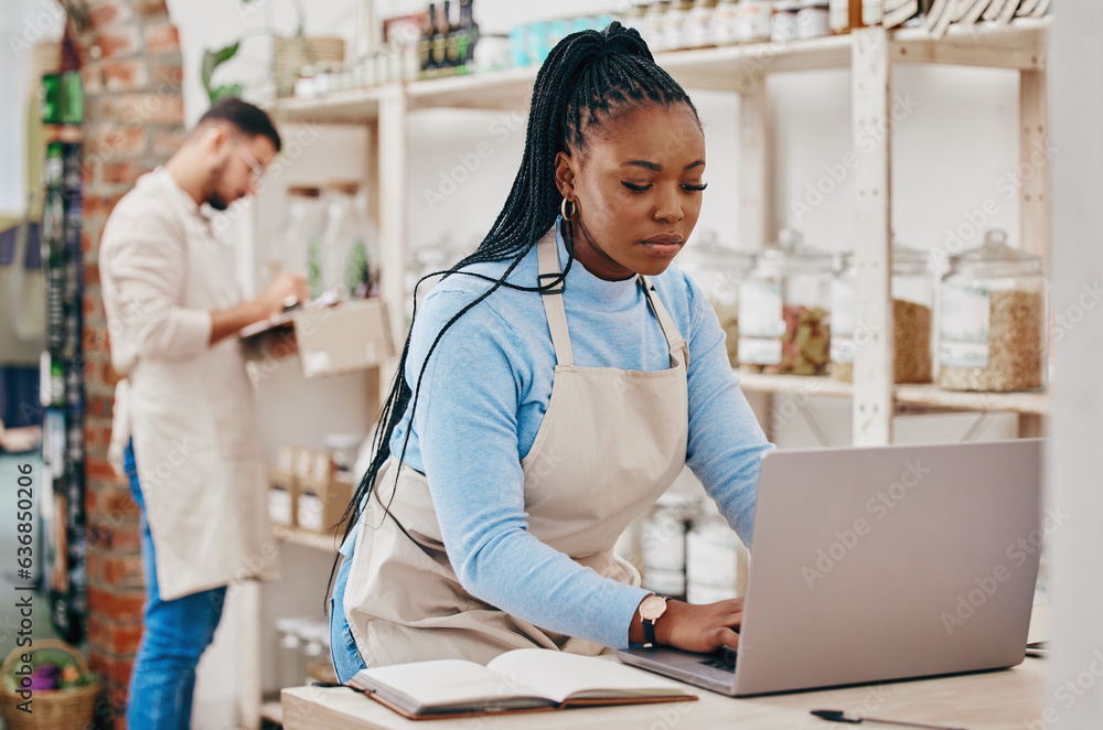 Grocery store, small business and black woman at counter with laptop for stock inventory, planning a