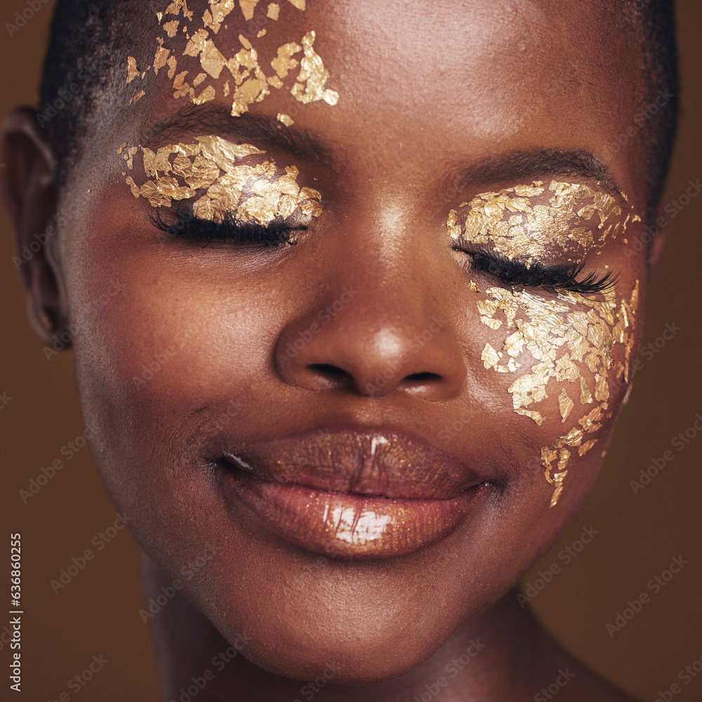 Gold, creative and black woman with makeup for beauty aesthetics isolated in a studio brown backgrou