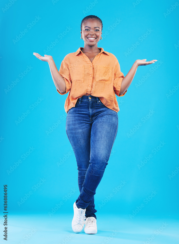 Portrait, showing and black woman with promotion, smile or opportunity on a blue studio background. 