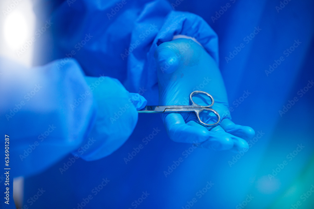 Closeup, surgery and hands with a scissor for healthcare, hospital work and help. Support, team and 