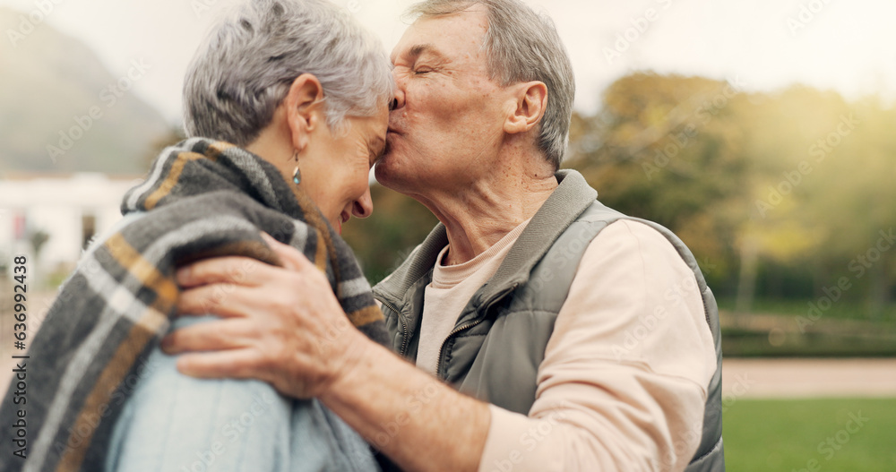 Kiss, forehead and senior couple in a park with love, happy and conversation with romantic bonding. 