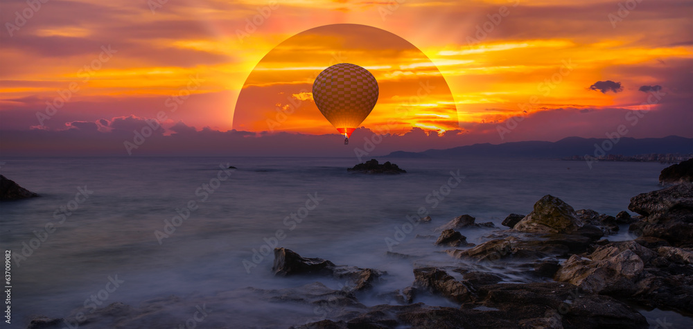 Hot air balloon flying over sunset sea - Long exposure photo - Beauty sunset over the sea - Beautifu