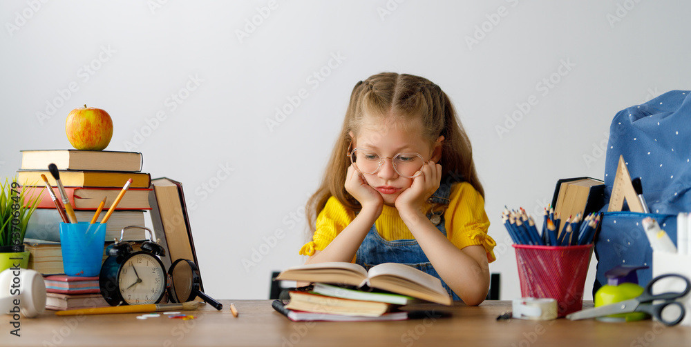 Thinking child is sitting at desk