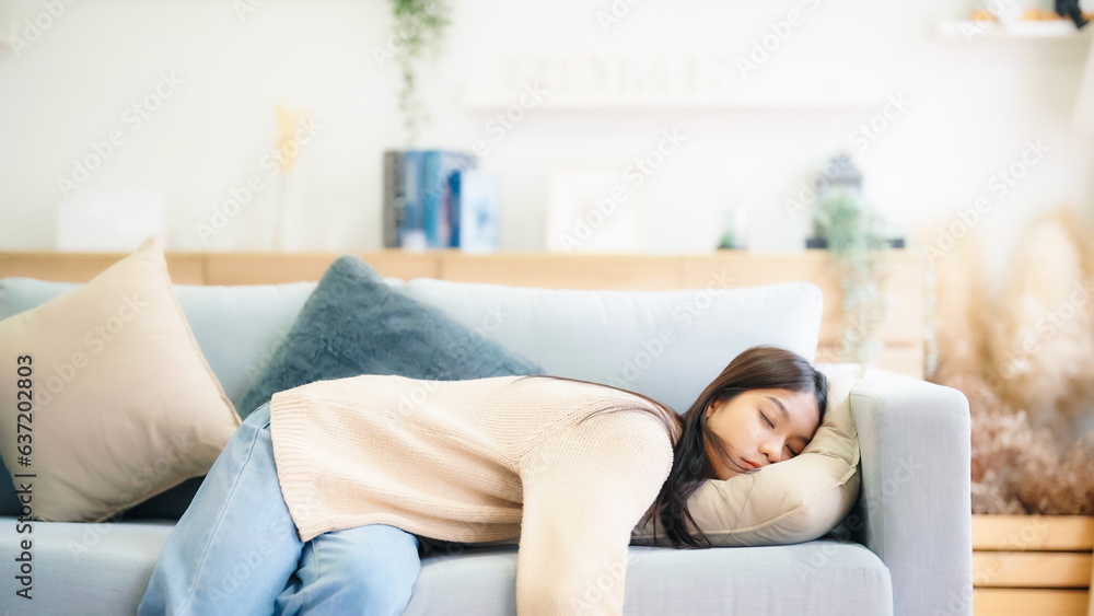 Asian woman resting at home on couch, feeling exhausted after work, lacking energy, or overworked, t