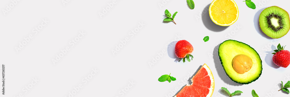 Avocado and mixed fruits overhead view flat lay