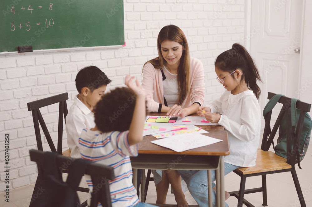 A group of children sit happily studying in the classroom.