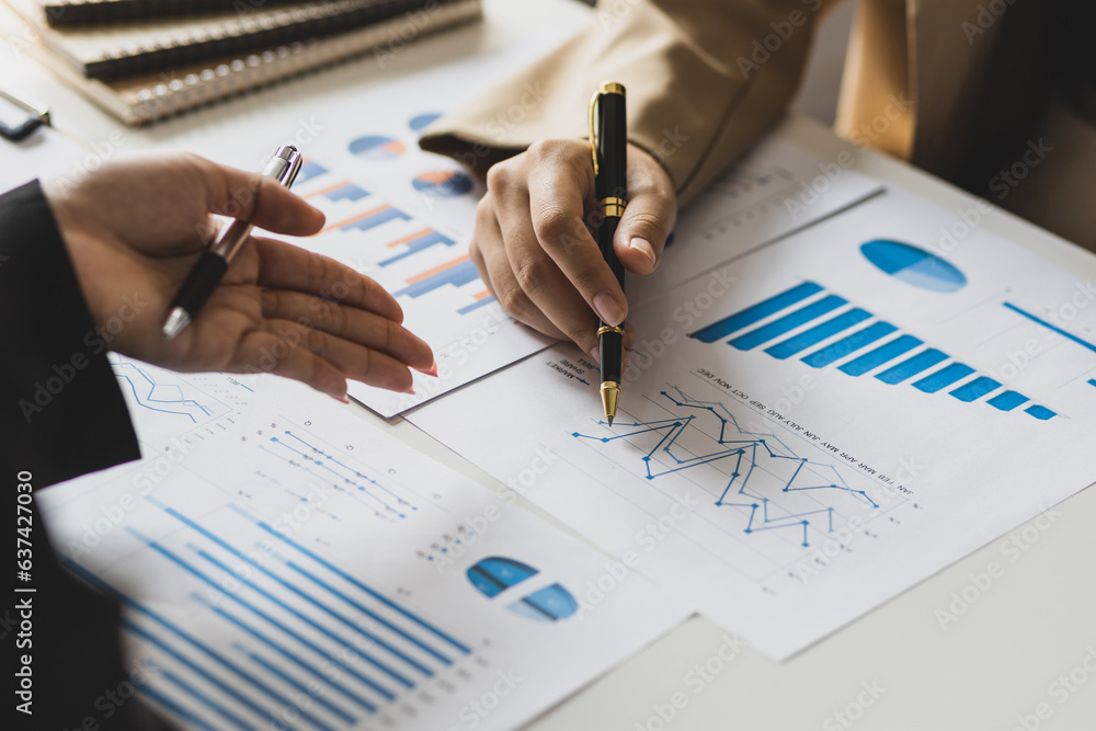 Meeting with financial advisors together analyzing financial charts in business reports. Business in