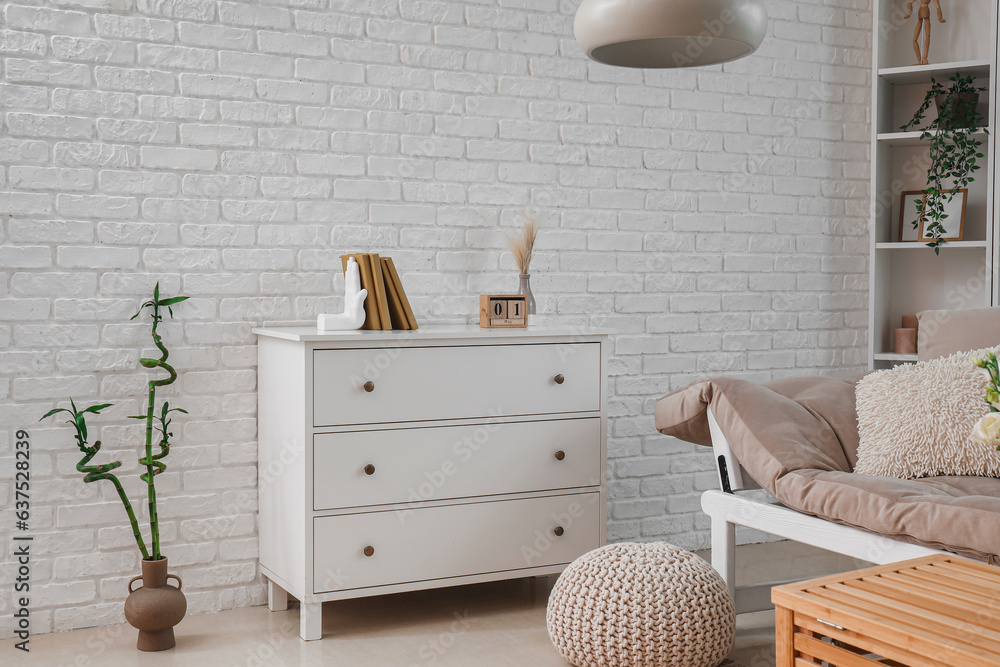 Interior of room with shelving unit and stylish holder for books near white wall