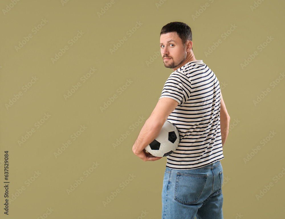 Man with soccer ball on color background