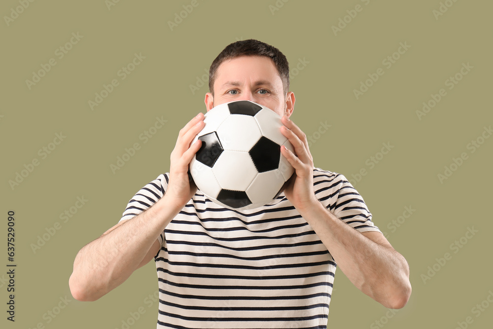 Man with soccer ball on color background