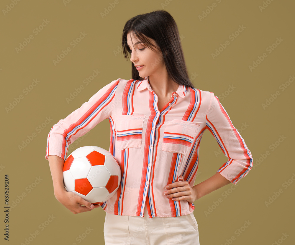 Young woman with soccer ball on color background