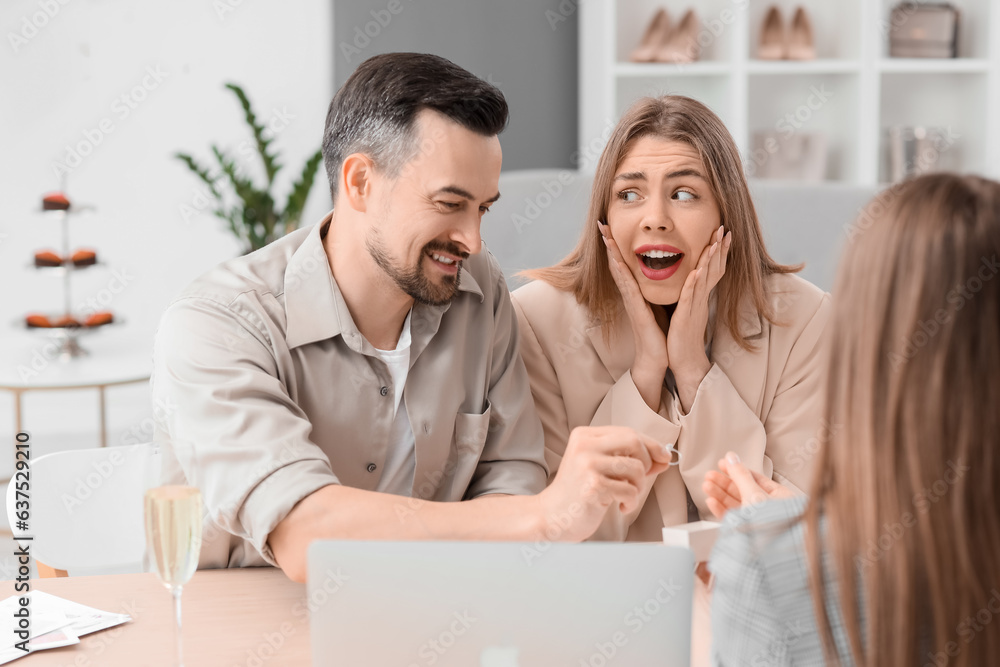 Young couple choosing ring for their wedding in office