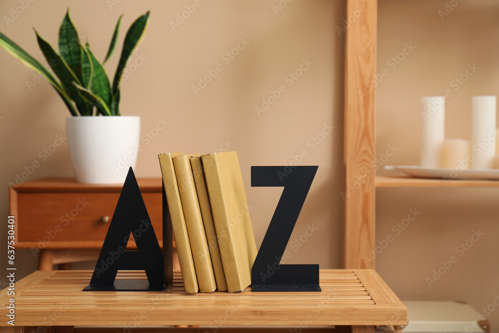 Stylish holder for books on wooden table in room