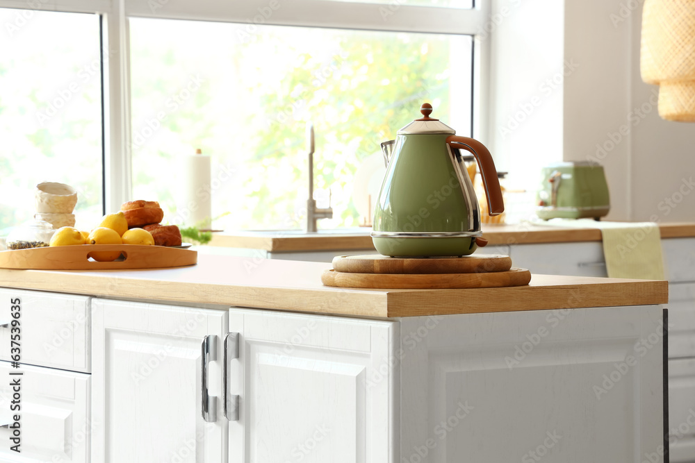 Electric kettle on wooden countertop in modern kitchen