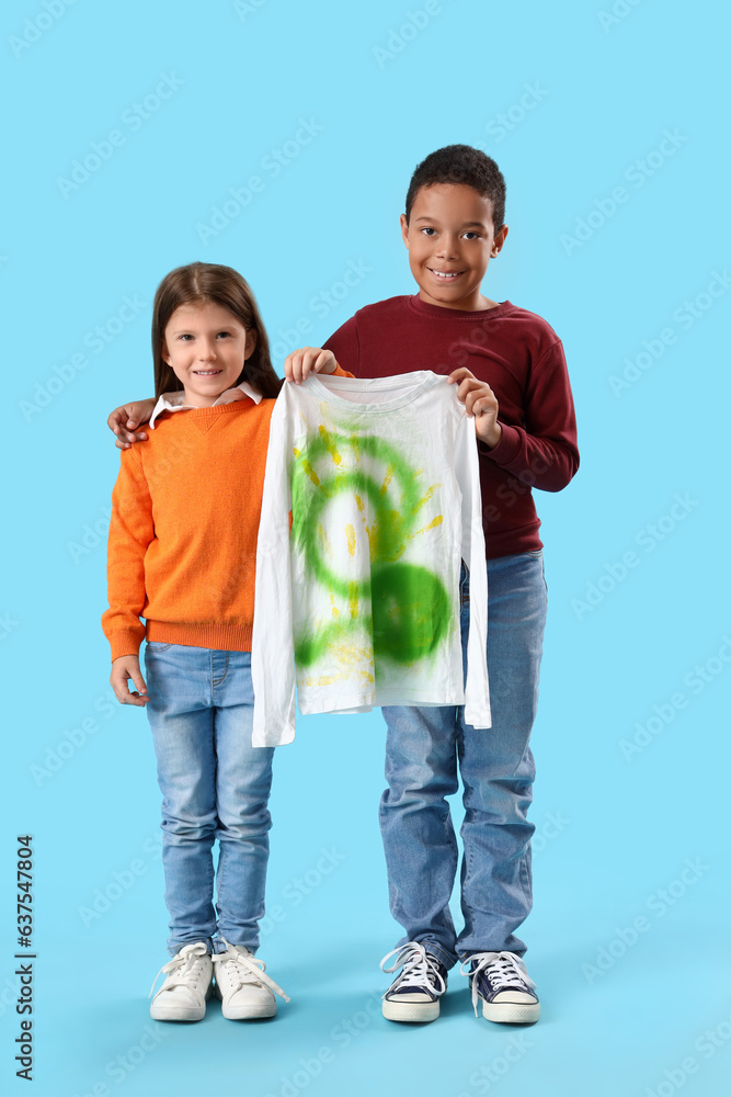 Cute little children with drawn clothes on blue background