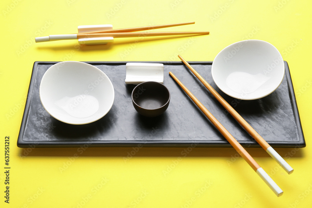 Chinese tableware on yellow background