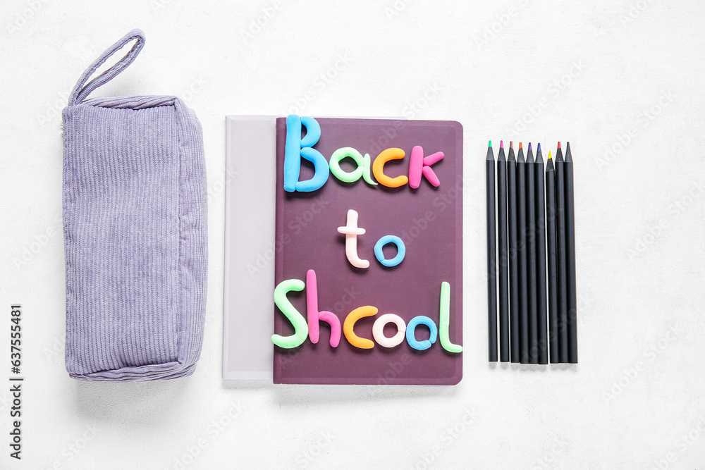 Text BACK TO SCHOOL and stationery on light background