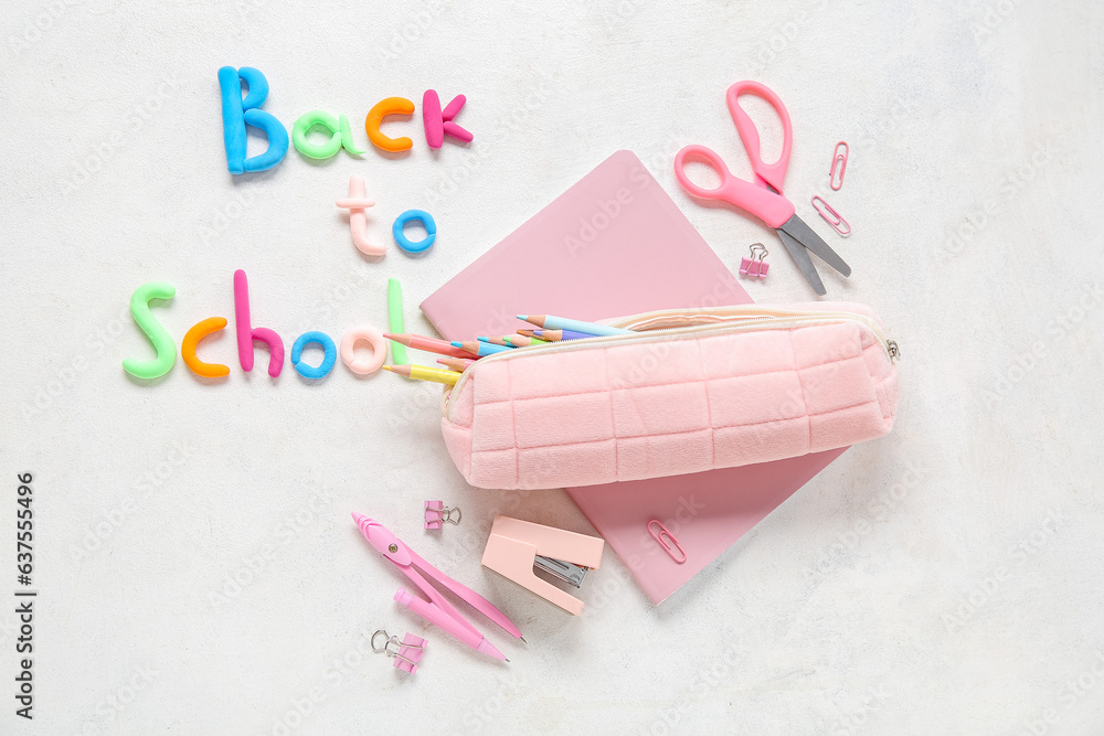 Text BACK TO SCHOOL and stationery on light background