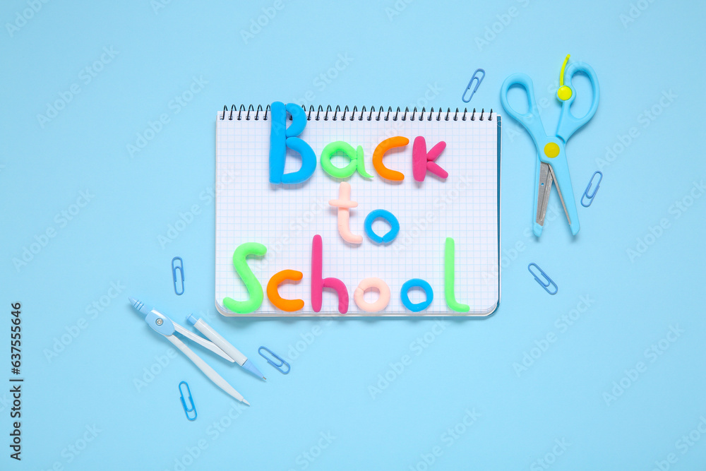 Text BACK TO SCHOOL and stationery on light blue background